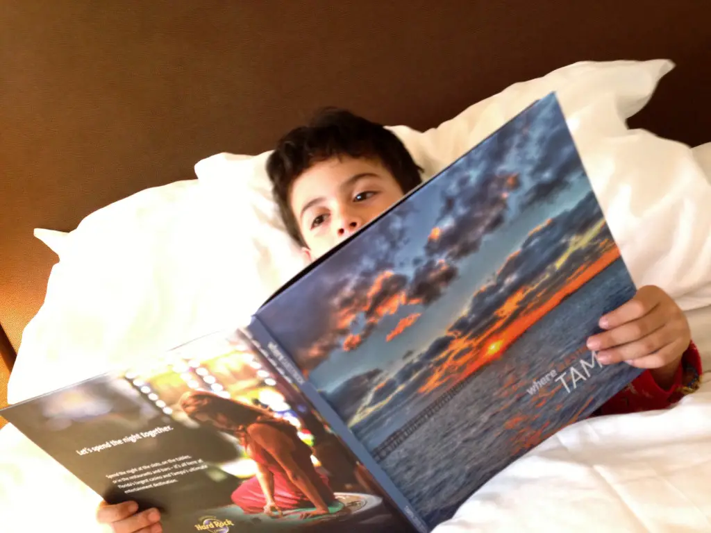 boy reading Tampa book in hotel