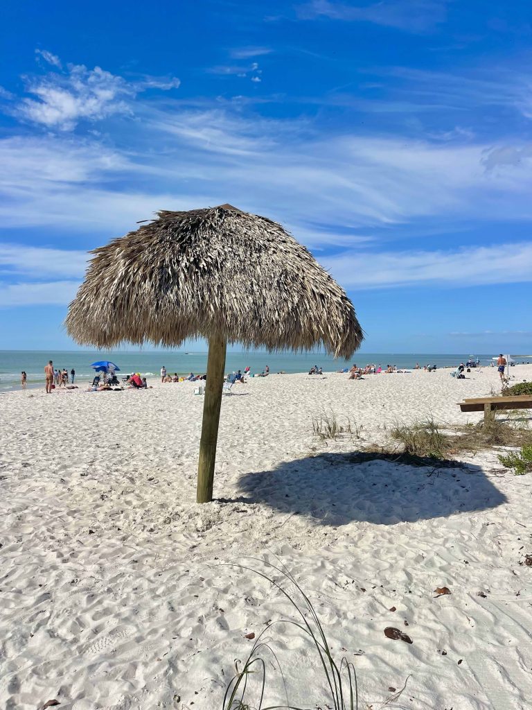 Free tiki hut shade on the sand at Lowdermilk Beach in Naples Florida
