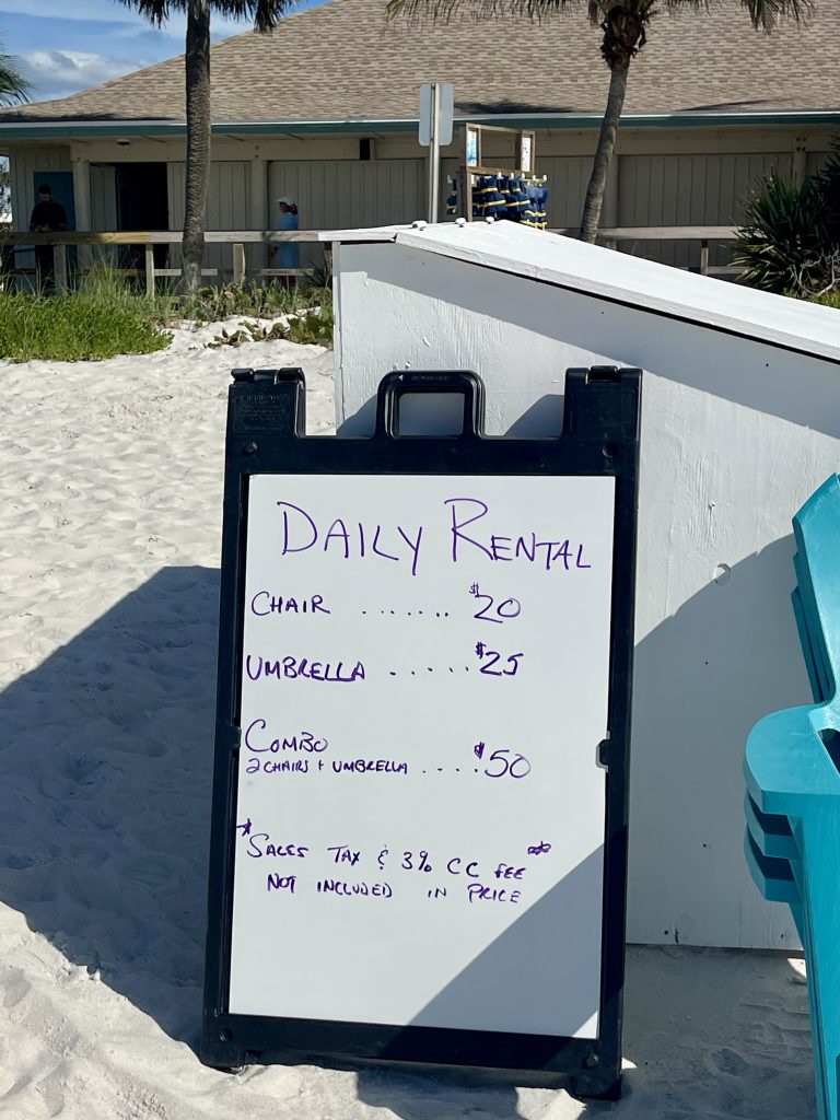 Daily chair and umbrella rental price sign at Lowdermilk Beach in Naples Florida