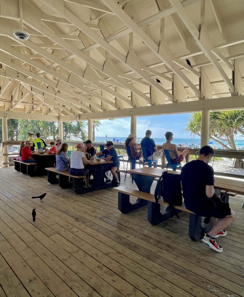 Shaded seating area at Flip Flops Beach Grill at Lowdermilk Beach in Naples Florida