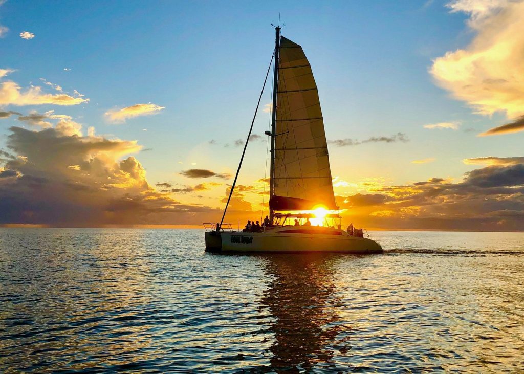 Catamaran sailing during sunset on the Gulf Coast near Naples Florida